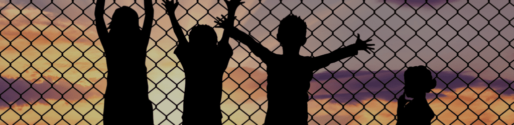 unaccompanied immigrant children in front of fence