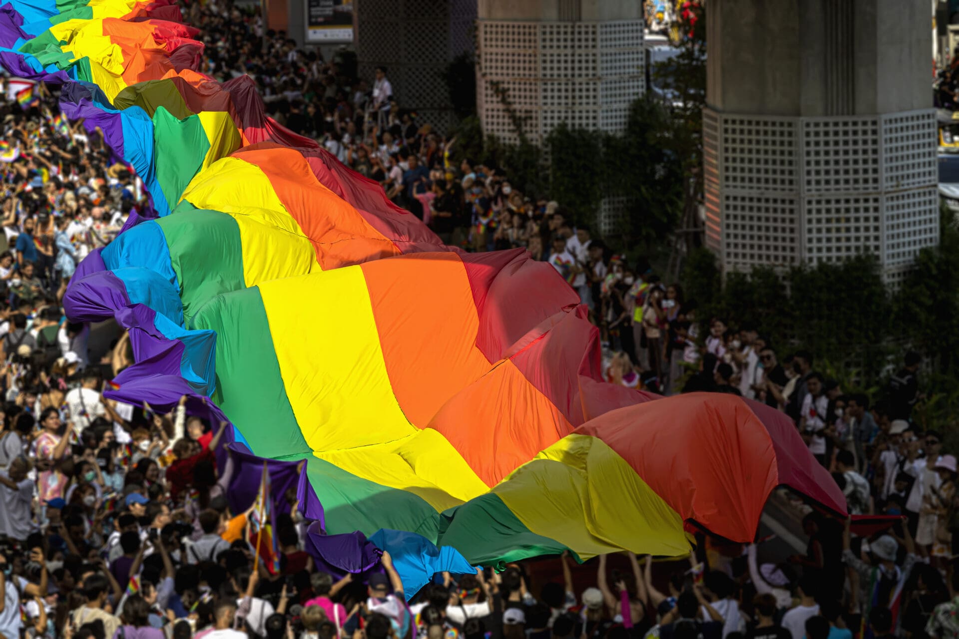 Pride Flag during Pride Month, and Parade-People Marching with The Rainbow LGBT flag