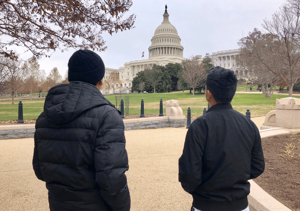 Two boys looking at the U.S. Capitol