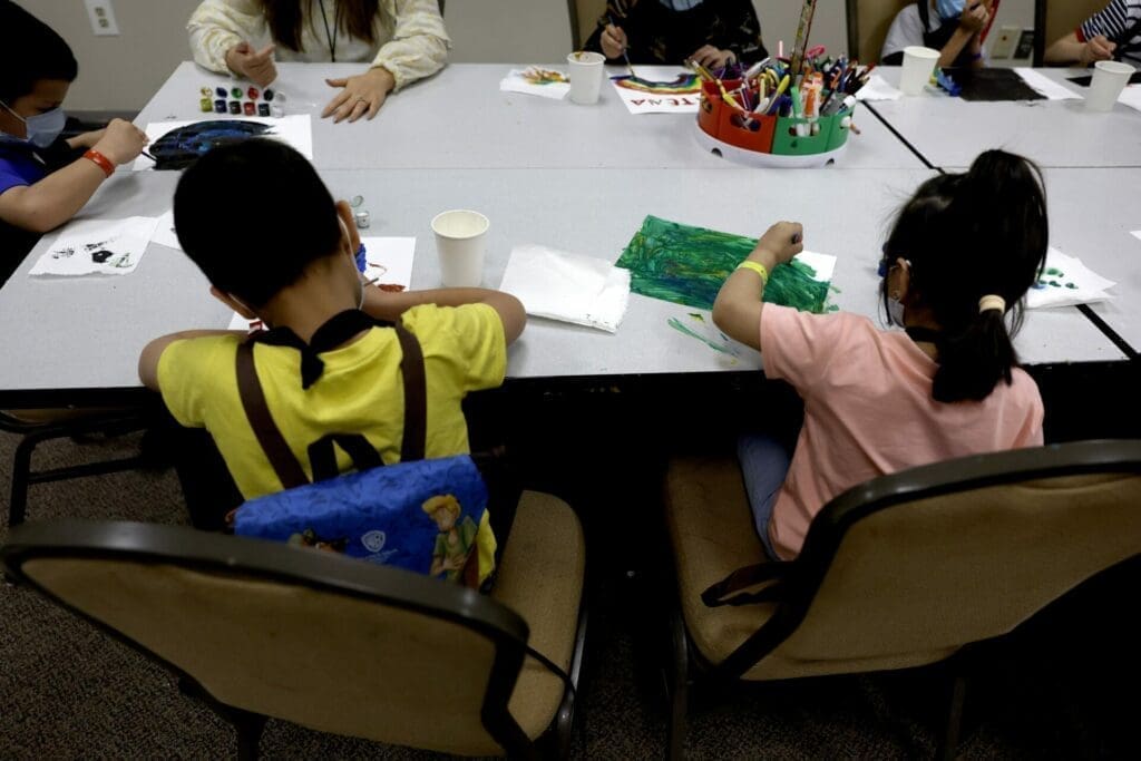 Young Afghan children paint in an art class at the National Conference Center (NCC)
