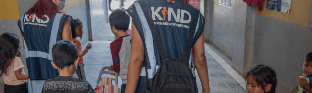 KIND staff walking with children at a shelter in Mexico