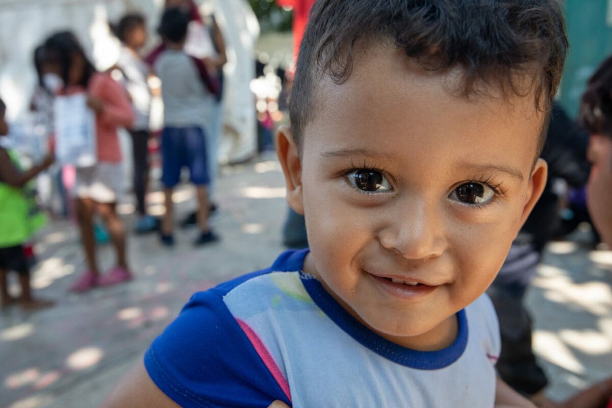 Young migrant boy smiling at the camer